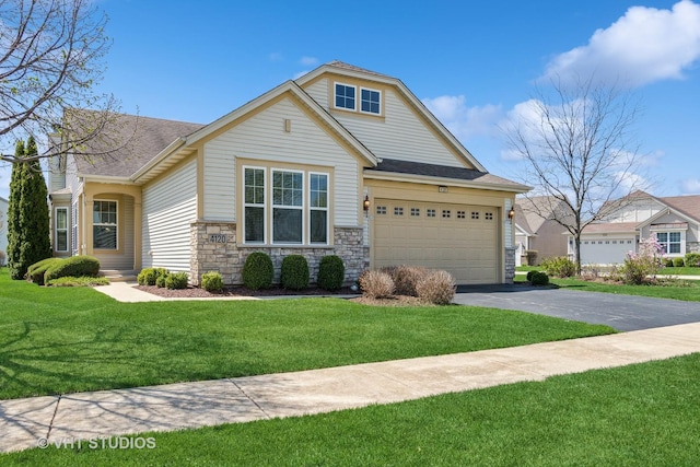 4120 Idlewild Ln, Naperville, IL 60564 - view of front of home with asphalt driveway, stone siding, an attached garage, and a front yard