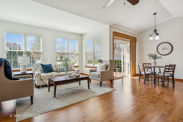 4120 Idlewild Ln, Naperville, IL 60564 - living area featuring plenty of natural light, wood-type flooring, lofted ceiling, ceiling fan, and a chandelier