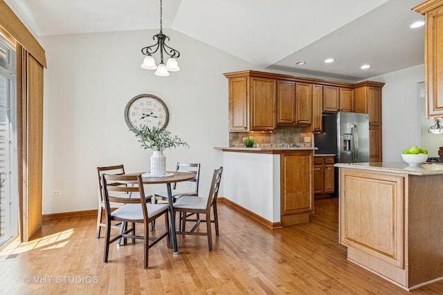 4120 Idlewild Ln, Naperville, IL 60564 - kitchen featuring a peninsula, light wood-type flooring, decorative backsplash, brown cabinets, and vaulted ceiling