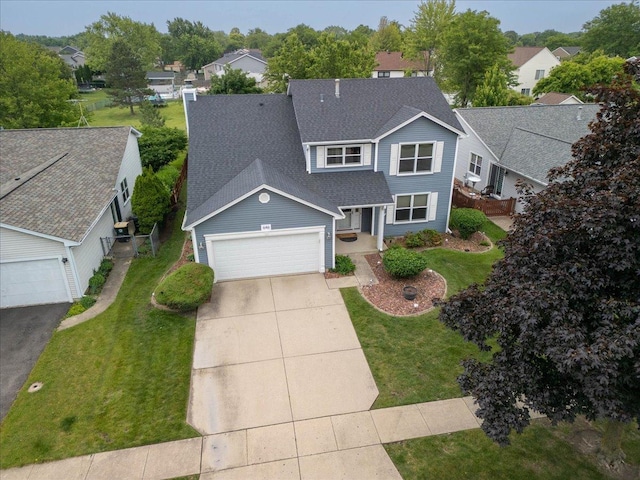 646 Schooner Ln, Elk Grove Village, IL 60007 - traditional home featuring roof with shingles, a garage, driveway, and a front lawn
