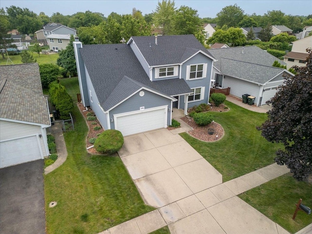 646 Schooner Ln, Elk Grove Village, IL 60007 - traditional-style home with driveway, an attached garage, roof with shingles, and a front lawn