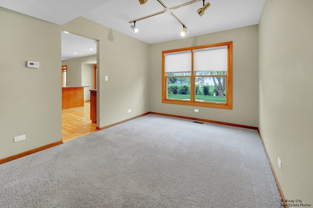 646 Schooner Ln, Elk Grove Village, IL 60007 - carpeted empty room with rail lighting and baseboards