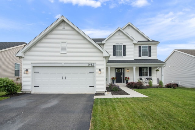 1462 Keller St, Elburn, IL 60119 - traditional-style house featuring driveway, a porch, a front yard, and a garage