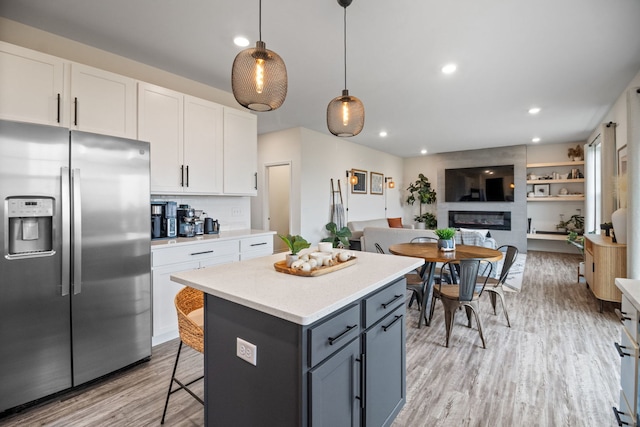 1462 Keller St, Elburn, IL 60119 - kitchen with stainless steel fridge with ice dispenser, white cabinetry, light countertops, open floor plan, and recessed lighting