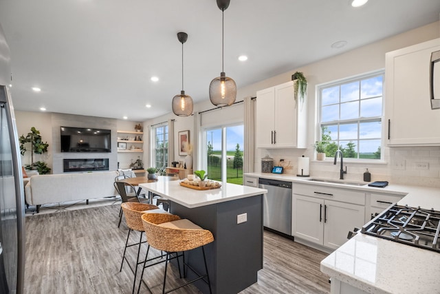 1462 Keller St, Elburn, IL 60119 - kitchen featuring stainless steel dishwasher, open floor plan, a center island, plenty of natural light, and recessed lighting