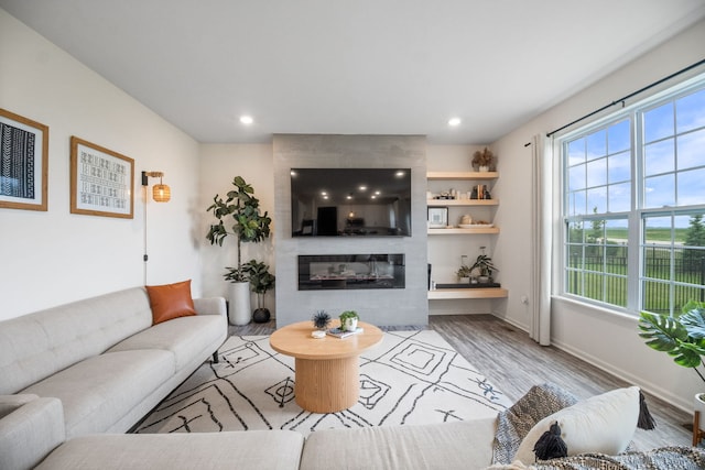 1462 Keller St, Elburn, IL 60119 - living room featuring healthy amount of natural light, wood finished floors, a large fireplace, and recessed lighting