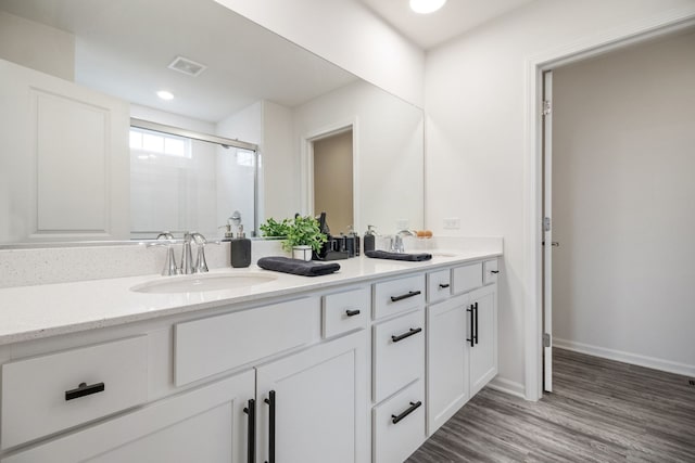 1462 Keller St, Elburn, IL 60119 - bathroom with double vanity, a stall shower, wood finished floors, and recessed lighting