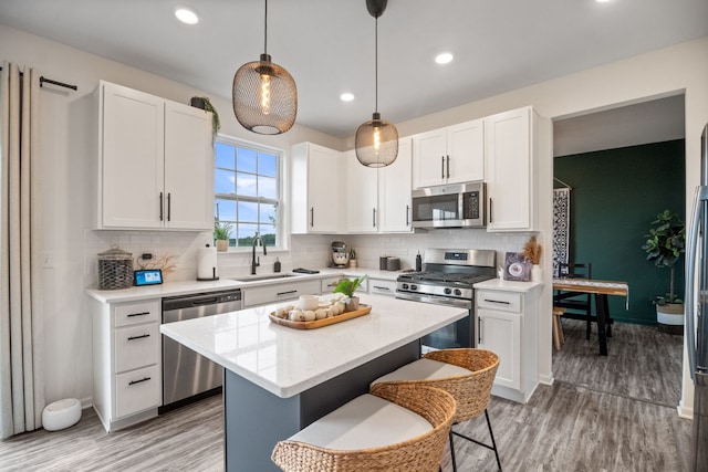 1462 Keller St, Elburn, IL 60119 - kitchen featuring stainless steel appliances, light wood-style flooring, decorative backsplash, white cabinetry, and recessed lighting