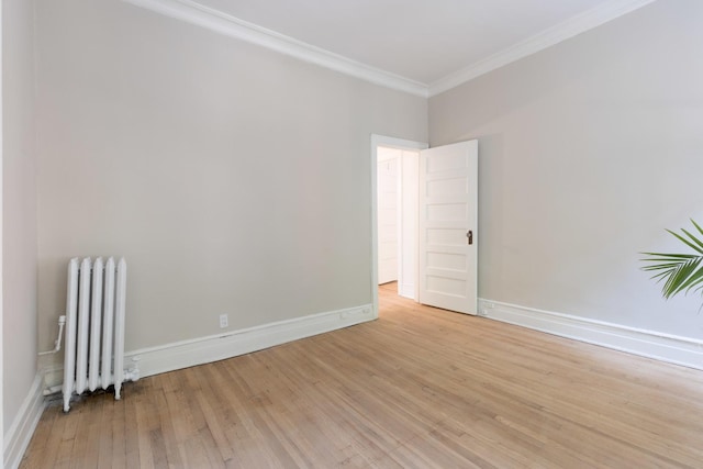 668 W Irving Park Rd Unit H1, Chicago, IL 60613 - unfurnished room featuring radiator, crown molding, and light wood-style floors