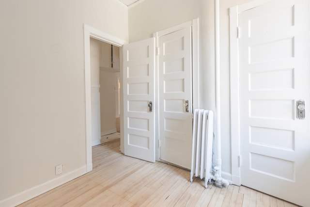 668 W Irving Park Rd Unit H1, Chicago, IL 60613 - unfurnished bedroom with radiator and light wood finished floors