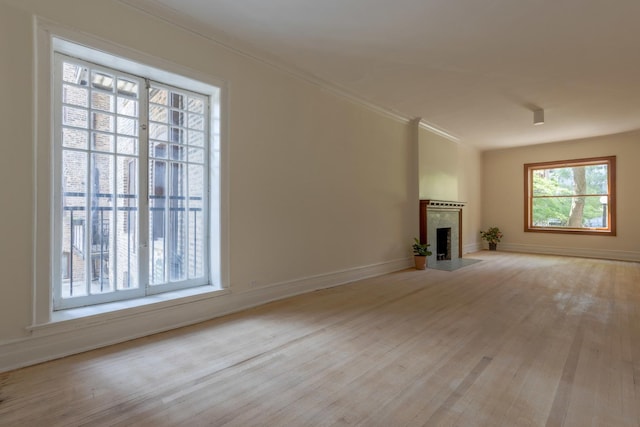 668 W Irving Park Rd Unit H1, Chicago, IL 60613 - unfurnished living room featuring wood finished floors, crown molding, and a tiled fireplace