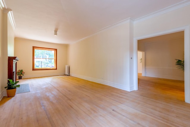 668 W Irving Park Rd Unit H1, Chicago, IL 60613 - unfurnished living room with radiator, light wood-style flooring, and crown molding
