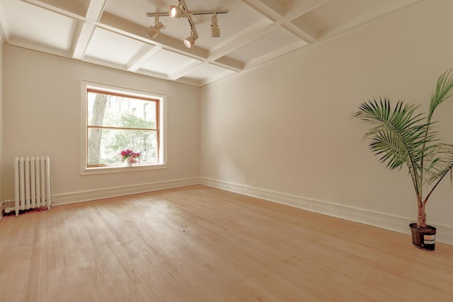 668 W Irving Park Rd Unit H1, Chicago, IL 60613 - unfurnished room with radiator, light wood finished floors, coffered ceiling, beam ceiling, and track lighting