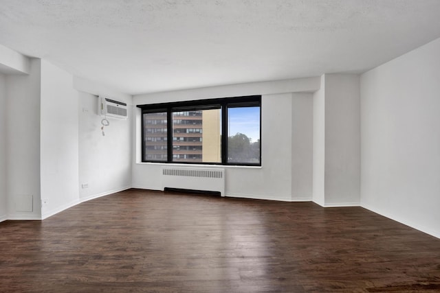3100 N Lake Shore Dr Unit 413, Chicago, IL 60657 - spare room featuring radiator, wood finished floors, and a wall mounted air conditioner
