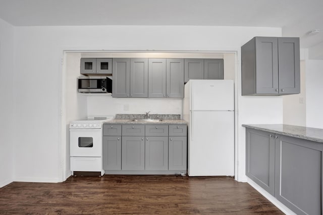3100 N Lake Shore Dr Unit 413, Chicago, IL 60657 - kitchen with white appliances, gray cabinetry, dark wood-style flooring, and light stone counters