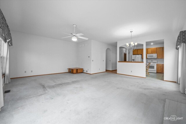 1909 Lakeside Dr, Montgomery, IL 60538 - unfurnished living room with arched walkways, a chandelier, light carpet, and ceiling fan