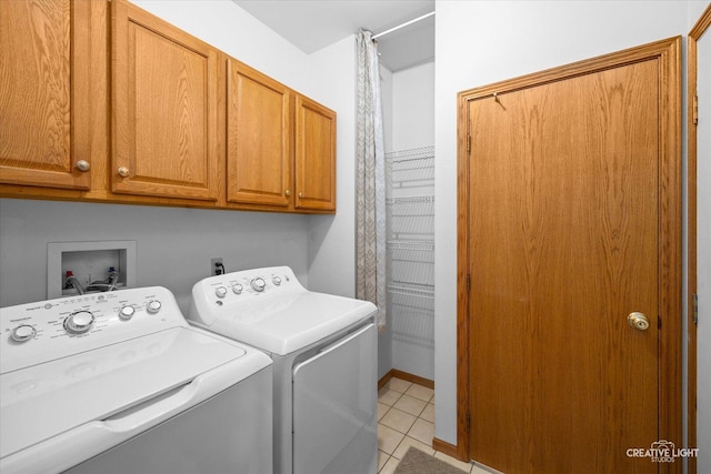 1909 Lakeside Dr, Montgomery, IL 60538 - laundry area with cabinet space, separate washer and dryer, and light tile patterned flooring