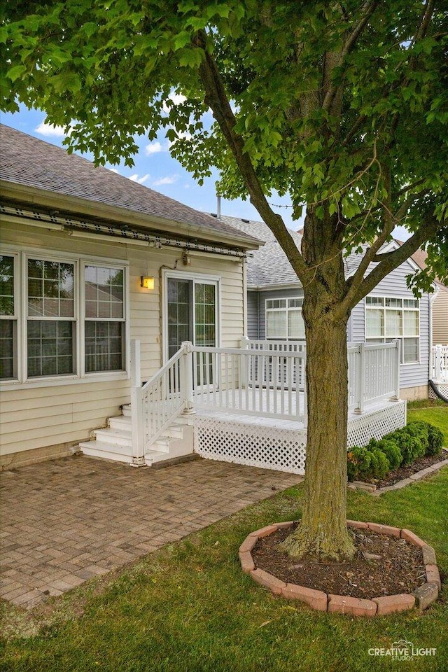1909 Lakeside Dr, Montgomery, IL 60538 - view of front facade with a patio area and a shingled roof