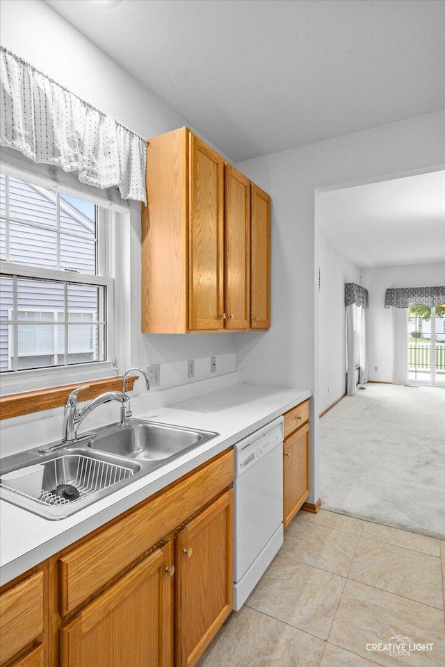 1909 Lakeside Dr, Montgomery, IL 60538 - kitchen featuring white dishwasher, light countertops, light carpet, and light tile patterned flooring