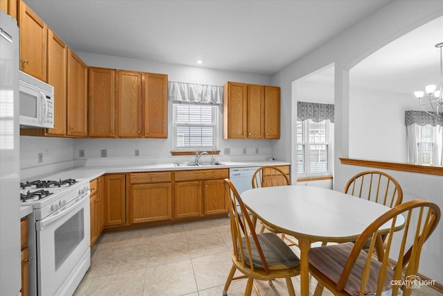 1909 Lakeside Dr, Montgomery, IL 60538 - kitchen featuring white appliances, a chandelier, healthy amount of natural light, light countertops, and recessed lighting