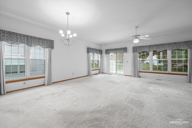 1909 Lakeside Dr, Montgomery, IL 60538 - carpeted empty room with a chandelier and a ceiling fan