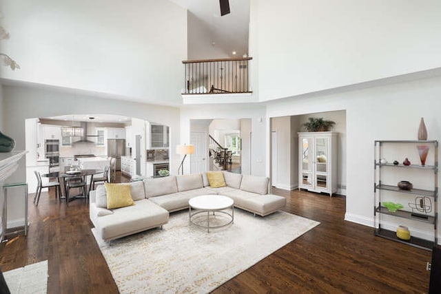 3527 Scottsdale Cir, Naperville, IL 60564 - living area with stairway, arched walkways, dark wood-type flooring, a high ceiling, and ceiling fan