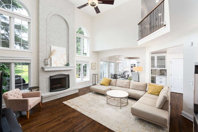 3527 Scottsdale Cir, Naperville, IL 60564 - living area with a high ceiling, wood finished floors, a ceiling fan, a large fireplace, and healthy amount of natural light