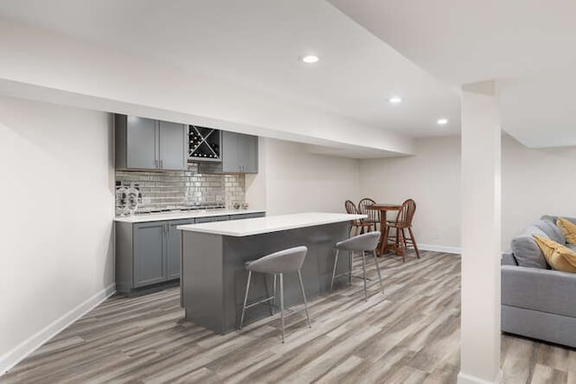 3527 Scottsdale Cir, Naperville, IL 60564 - kitchen featuring gray cabinetry, light wood finished floors, a kitchen breakfast bar, light countertops, and recessed lighting