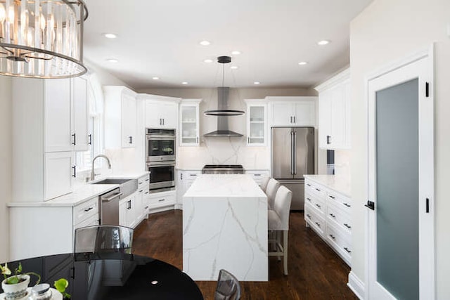 3527 Scottsdale Cir, Naperville, IL 60564 - kitchen with stainless steel appliances, wall chimney range hood, a center island, white cabinets, and dark wood-type flooring