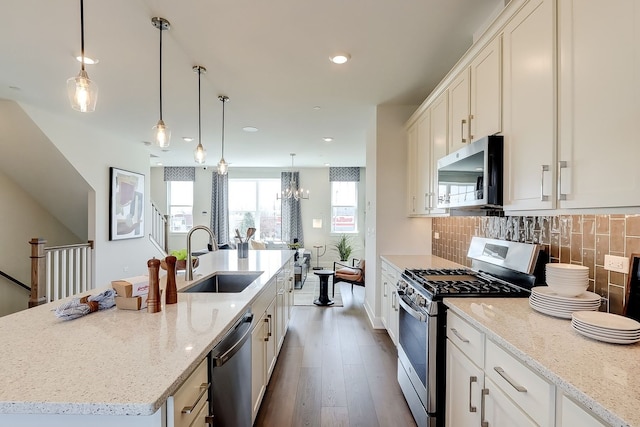 1058 E Oakton St, Des Plaines, IL 60018 - kitchen with appliances with stainless steel finishes, backsplash, dark wood-type flooring, light stone countertops, and recessed lighting