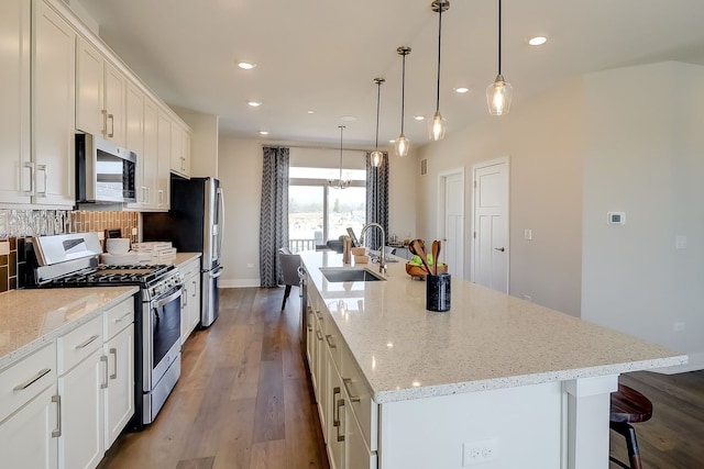 1058 E Oakton St, Des Plaines, IL 60018 - kitchen with appliances with stainless steel finishes, a large island with sink, dark wood-style floors, white cabinets, and recessed lighting