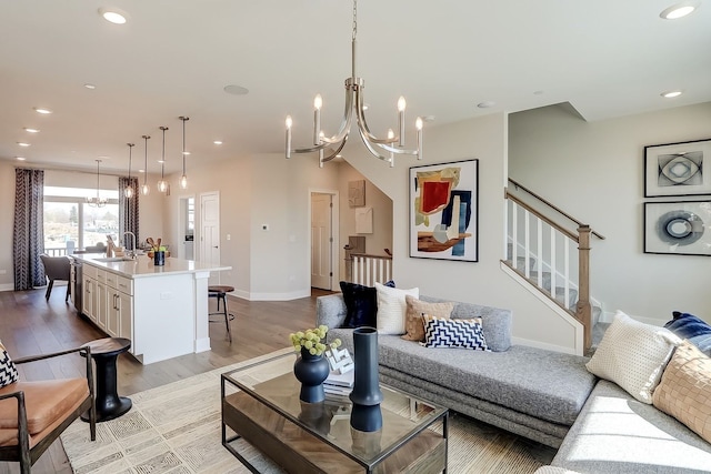1058 E Oakton St, Des Plaines, IL 60018 - living room featuring a chandelier, light wood-style flooring, stairway, and recessed lighting