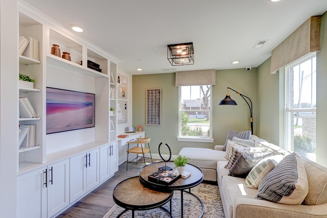 1060 E Oakton St, Des Plaines, IL 60018 - living area featuring healthy amount of natural light, built in shelves, wood finished floors, and recessed lighting