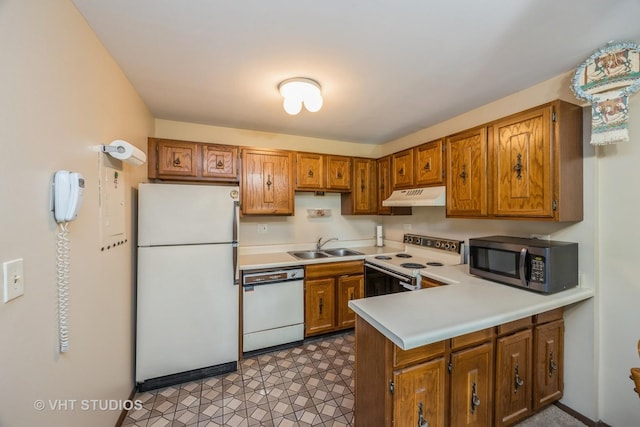 4436 Arbor Cir Unit 4, Downers Grove, IL 60515 - kitchen with white appliances, under cabinet range hood, a peninsula, brown cabinets, and light countertops
