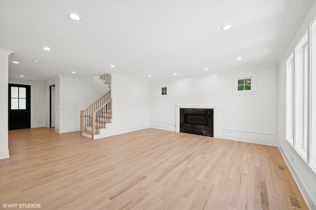 900 Pleasant Ln, Glenview, IL 60025 - unfurnished living room with light wood finished floors, recessed lighting, stairs, a high end fireplace, and ornamental molding