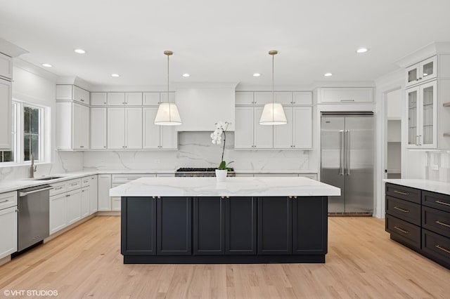 900 Pleasant Ln, Glenview, IL 60025 - kitchen with stainless steel appliances, a center island, white cabinets, decorative backsplash, and recessed lighting