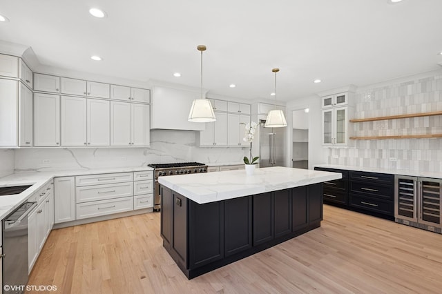 900 Pleasant Ln, Glenview, IL 60025 - kitchen with beverage cooler, stainless steel appliances, white cabinetry, decorative backsplash, and a kitchen island