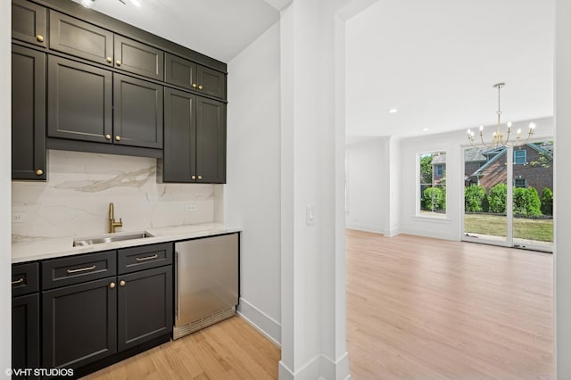 900 Pleasant Ln, Glenview, IL 60025 - bar area with a chandelier, light wood finished floors, stainless steel fridge, tasteful backsplash, and recessed lighting