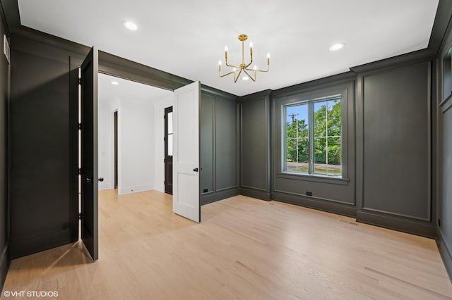 900 Pleasant Ln, Glenview, IL 60025 - empty room with a decorative wall, a chandelier, light wood finished floors, and recessed lighting