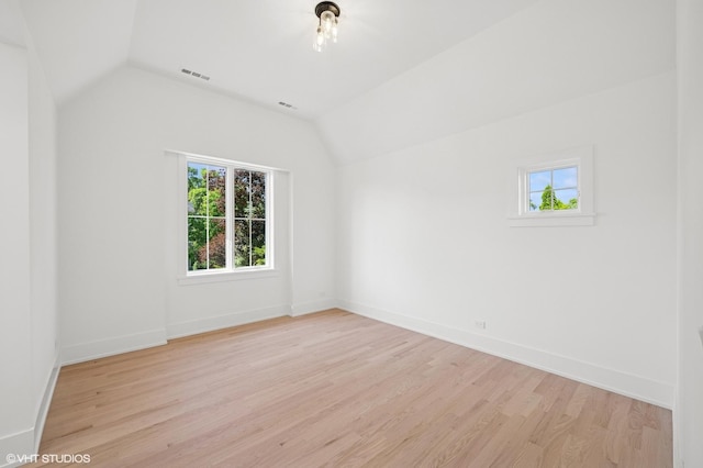 900 Pleasant Ln, Glenview, IL 60025 - unfurnished room with plenty of natural light, lofted ceiling, and light wood-style flooring