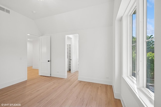 900 Pleasant Ln, Glenview, IL 60025 - unfurnished room featuring light wood-style floors and vaulted ceiling