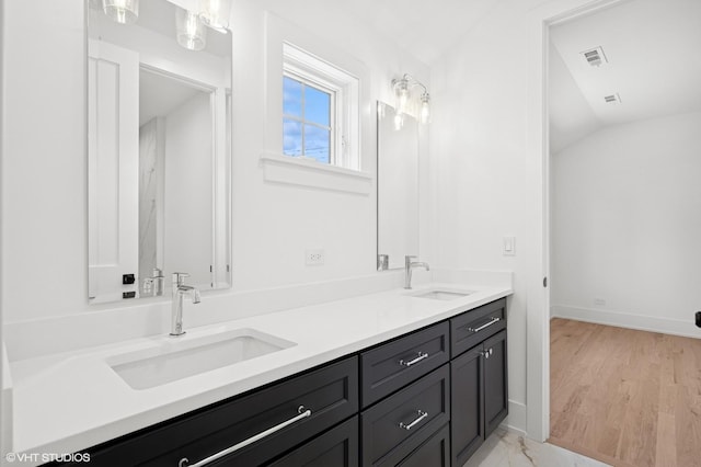 900 Pleasant Ln, Glenview, IL 60025 - bathroom featuring double vanity and lofted ceiling