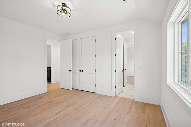 900 Pleasant Ln, Glenview, IL 60025 - unfurnished bedroom featuring light wood-style floors and multiple windows
