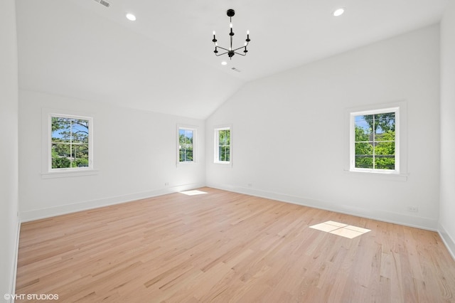 900 Pleasant Ln, Glenview, IL 60025 - empty room with healthy amount of natural light, a chandelier, vaulted ceiling, recessed lighting, and light wood finished floors