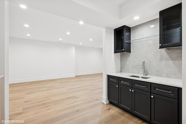 900 Pleasant Ln, Glenview, IL 60025 - kitchen with light wood-style flooring, tasteful backsplash, light countertops, glass insert cabinets, and recessed lighting