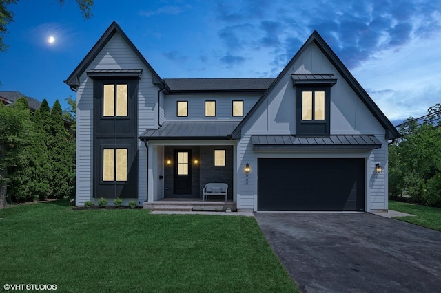900 Pleasant Ln, Glenview, IL 60025 - modern farmhouse featuring a standing seam roof, driveway, a front lawn, covered porch, and a metal roof