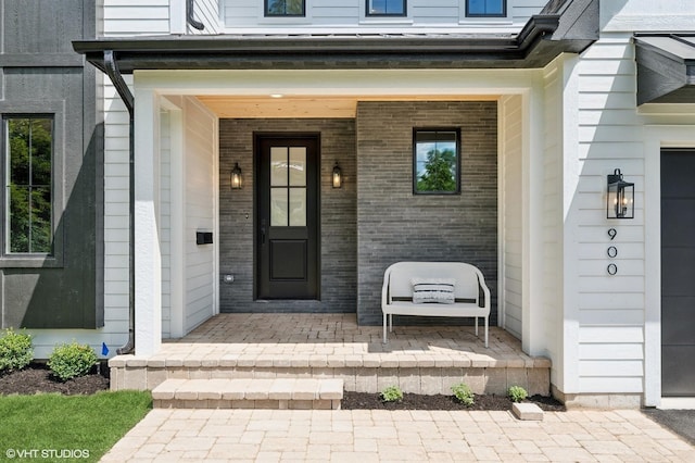900 Pleasant Ln, Glenview, IL 60025 - doorway to property featuring covered porch and brick siding