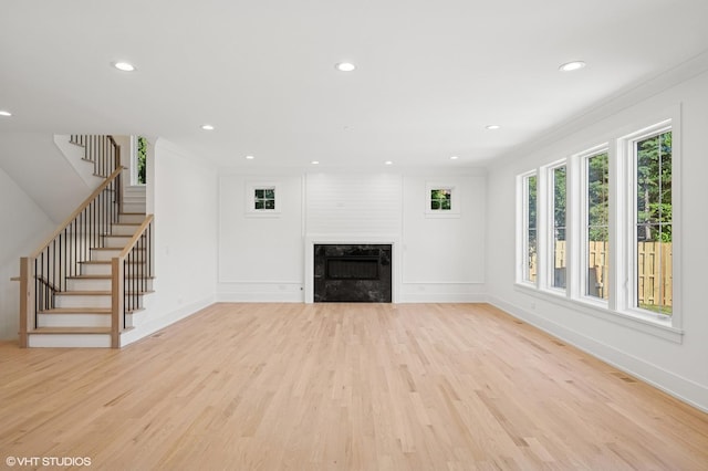 900 Pleasant Ln, Glenview, IL 60025 - unfurnished living room with light wood finished floors, stairway, ornamental molding, recessed lighting, and a fireplace
