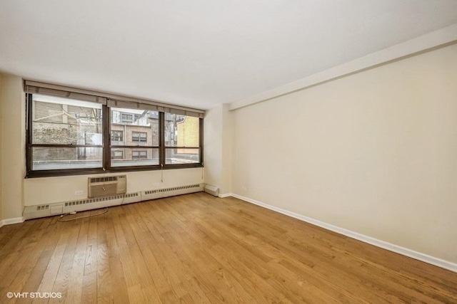 33 E Cedar St Unit 3D, Chicago, IL 60611 - empty room featuring light wood-type flooring and a baseboard heating unit