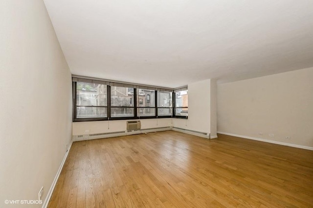 33 E Cedar St Unit 3D, Chicago, IL 60611 - empty room with light wood-style flooring and an AC wall unit